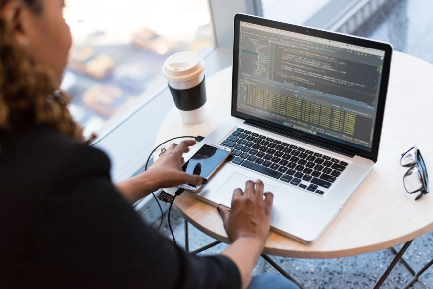 Person working on laptop, researching why employees shouldn't have admin access to their local machine